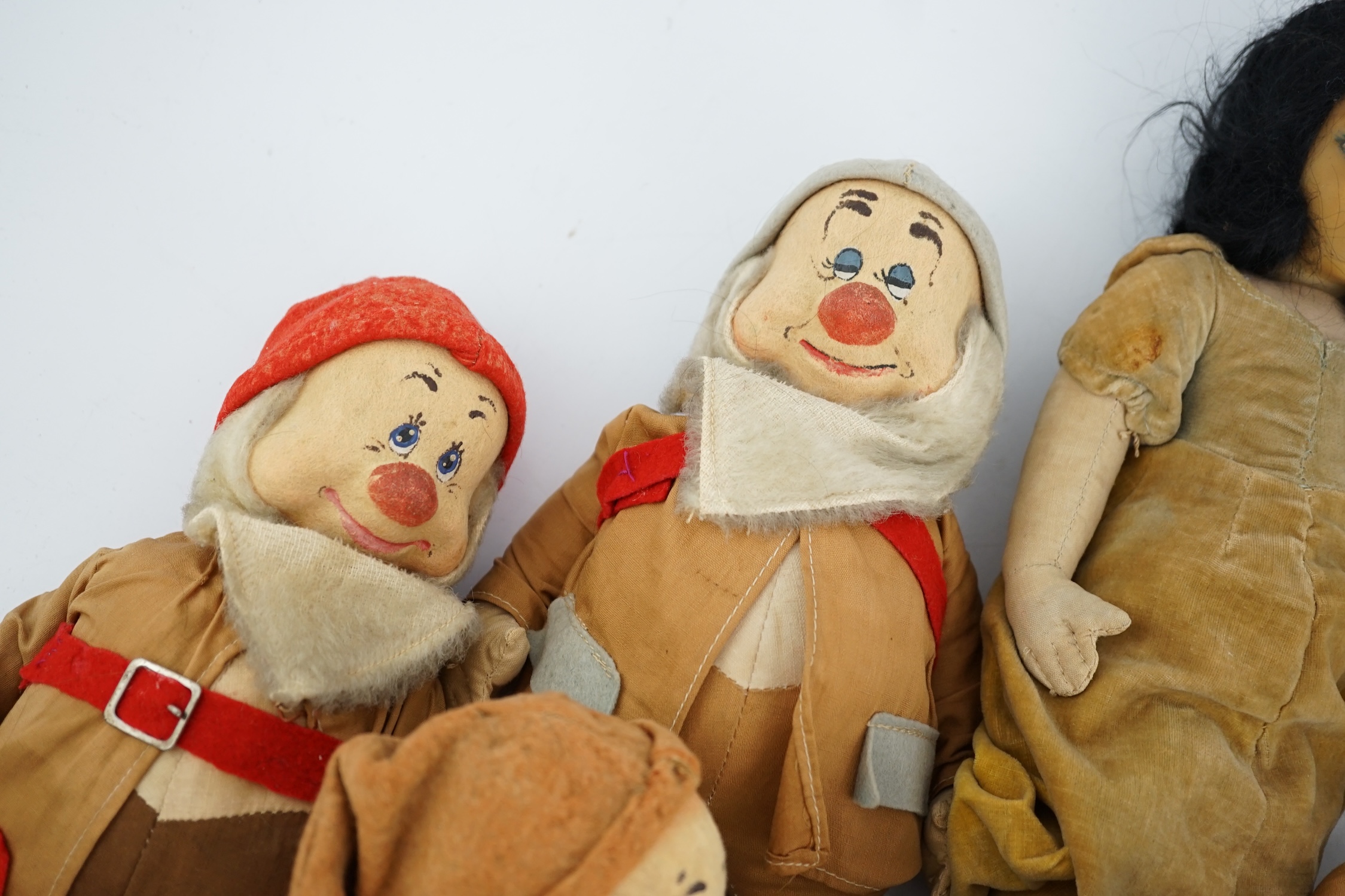 A set of Merrythought Snow White and the Seven Dwarves, Snow White with Merrythought label to the sole of her foot, the Dwarves could possibly be made by either Merrythought or Chad Valley, Snow White 36cm high